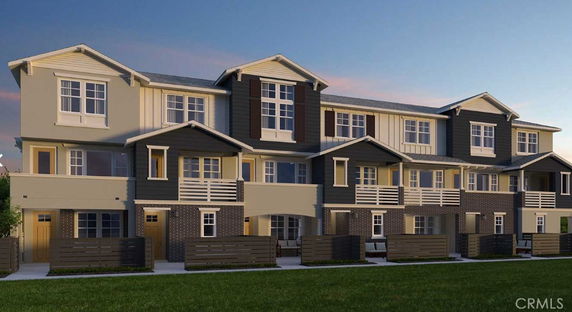 Front view of a three-story townhouse complex with multiple units.