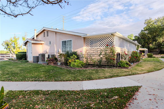 Front view of a single-story house with a landscaped garden.