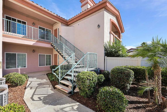 Front view of a two-story building with exterior stairs and balconies.