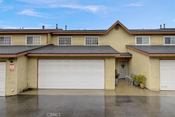Front view of a two-story townhouse with an attached double garage.