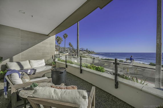 Outdoor seating area with ocean view and walkway.