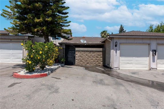 Front view of a single-story house with two white garage doors.