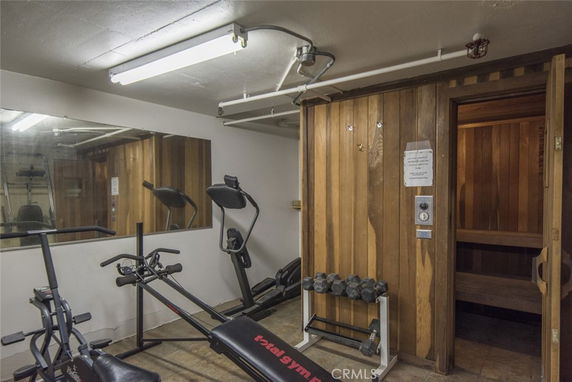 Indoor gym area with exercise equipment and a sauna room.