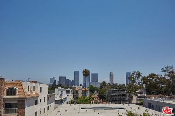 Panoramic cityscape view with buildings and clear sky.