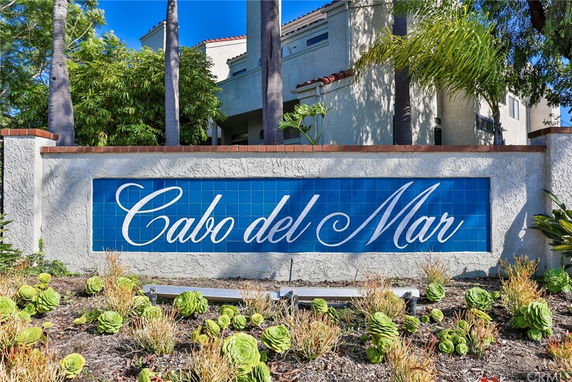 Front view of a building with a sign reading 'Cabo del Mar' on a wall.
