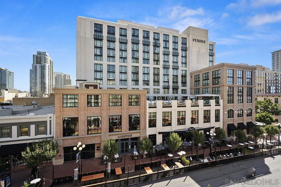 Front view of a multi-story commercial building with large windows and signage.