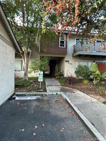 Front view of a residential building with a balcony.