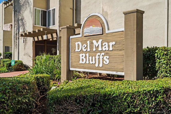 Front view of a building with a sign reading 'Del Mar Bluffs'.