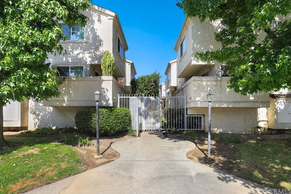 Front view of a multi-story building with gated entry