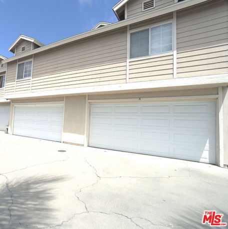 Front view of a multi-story building with multiple garage doors.