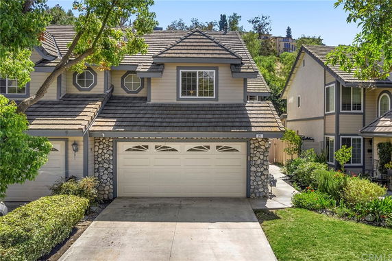Front view of a two-story house with a stone-accented facade and double garage.