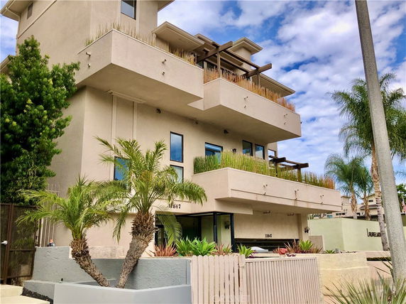 Front view of a multi-story building with balconies.