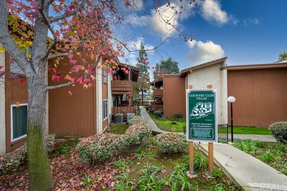 Front view of a residential complex with multiple buildings and a pathway.