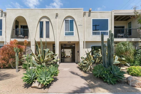 Front view of a two-story building with arched features and balconies.