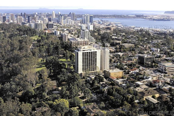 Panoramic view of a city skyline and surrounding landscape.