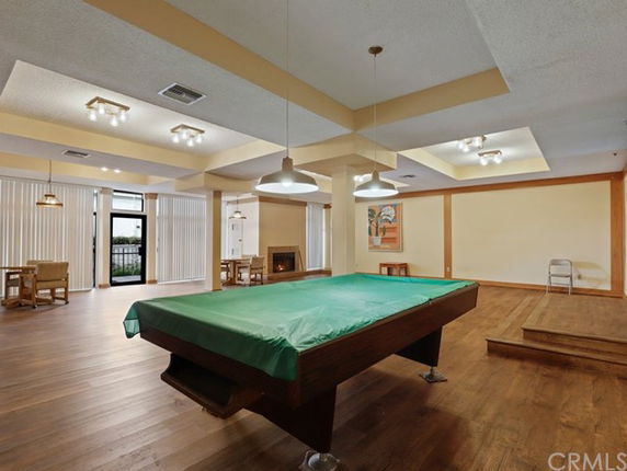 Indoor recreation room with a billiard table and seating area.