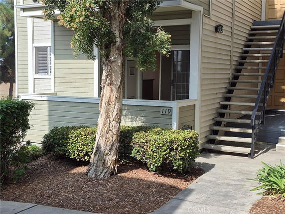 Front view of a two-story building with stairs leading to the upper level.