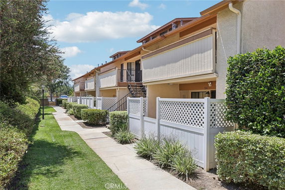 Front view of a multi-story residential building with balconies.