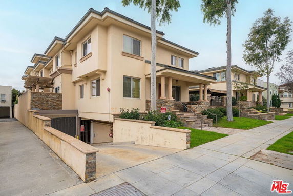 Front view of a two-story building with a modern design and stone accents.