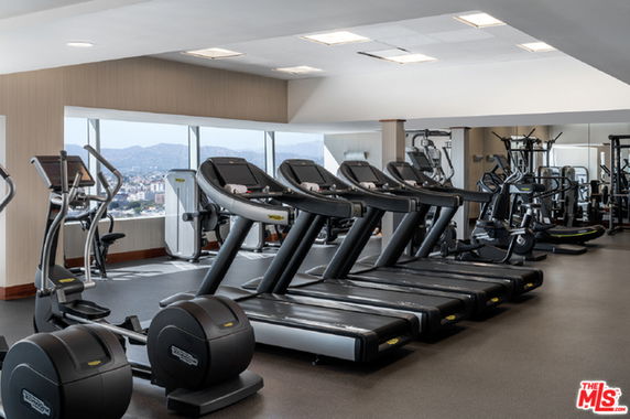 Indoor gym with multiple treadmills and exercise equipment.