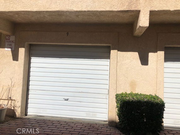 Front view of a building with a single garage door.