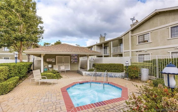 Outdoor area with a small swimming pool and adjacent building.