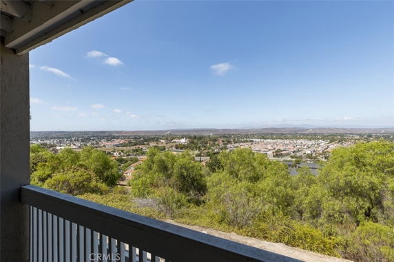 Panoramic view from a high vantage point overlooking a cityscape and greenery.