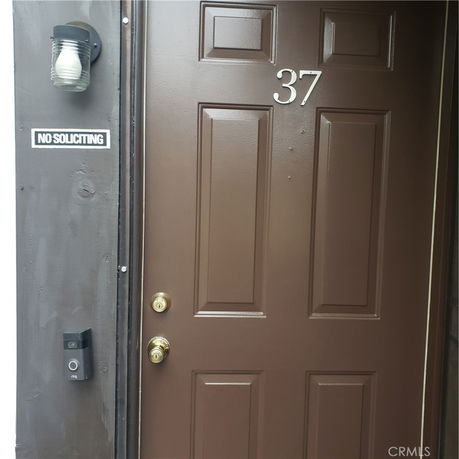 Front view of a brown door with house number 37.