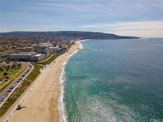 Panoramic view of a coastal area with a beach and ocean.