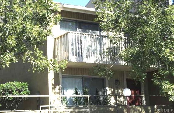 Front view of a two-story building with a balcony.