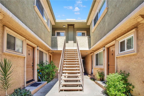 Front view of a two-story apartment building with an outdoor staircase.
