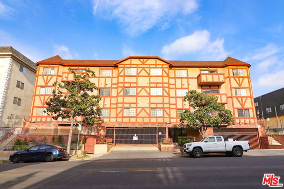 Front view of a multi-story building with a distinctive geometric facade.