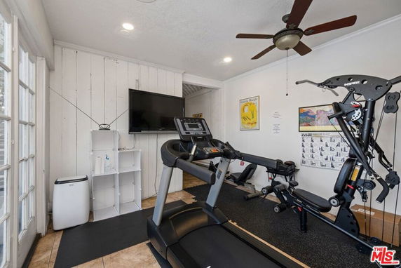 Indoor gym area with treadmill and exercise equipment.