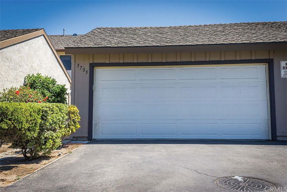Front view of a house with a double garage door.