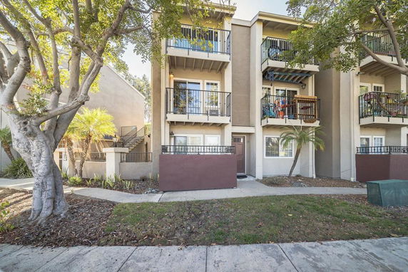 Front view of a multi-story residential building with balconies.
