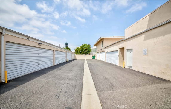 Outdoor parking area with multiple garage doors.