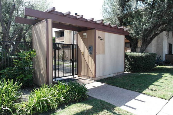 Front view of a small gated entrance structure.