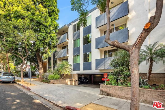 Front view of a multi-story residential building with balconies.