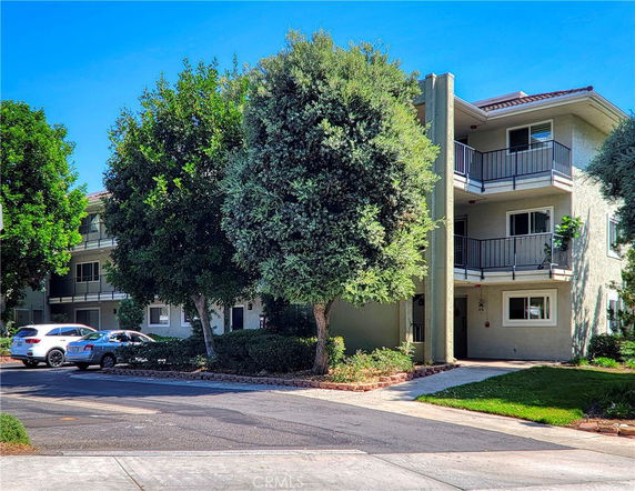 Front view of a multi-story residential building with balconies.