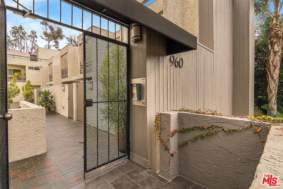 Front view of a multi-story building with gated entrance.