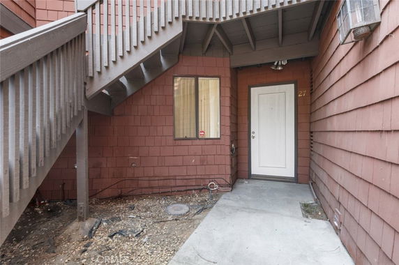 Entrance to a building with an exterior staircase and door.