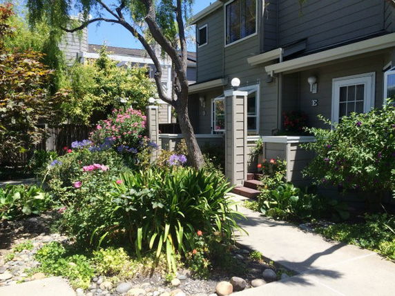 Front view of a two-story house with a garden entrance.