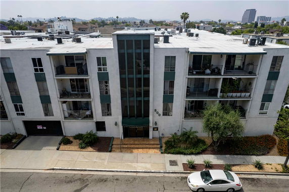 Front view of a multi-story residential building with balconies.