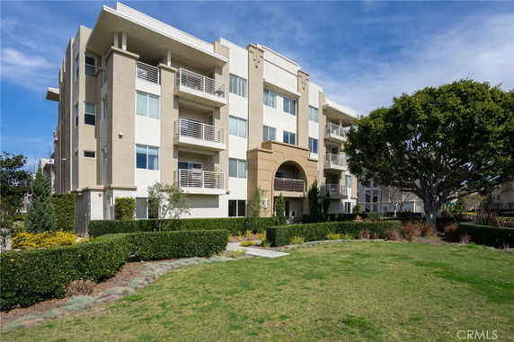 Front view of a multi-story residential building with balconies.