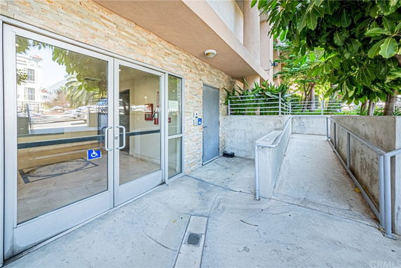 Entrance view of a building with ramp access and glass doors.