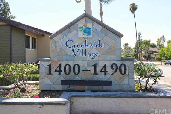 Entrance sign for Creekside Village with address 1400-1490.