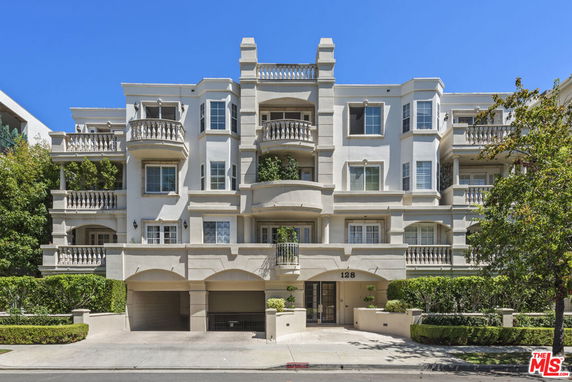 Front view of a multi-story apartment building with balconies.