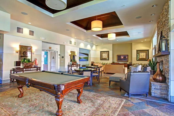 Interior view of a clubhouse with a pool table and seating area.