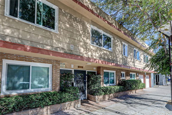 Front view of a two-story residential building with multiple windows.