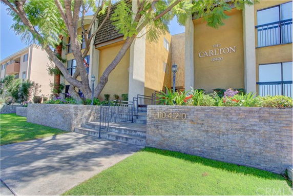 Front view of a multi-story building named 'The Carlton' with stairs leading to the entrance.